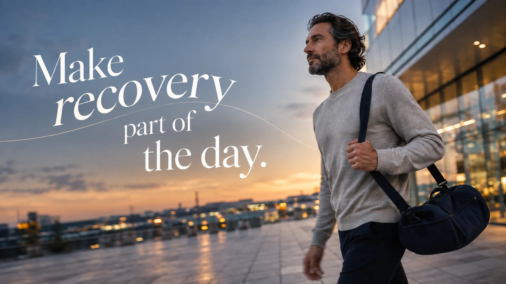 A man carrying a gym bag by the waterfront at sunset, with the words Make recovery part of the day and a fine wave line