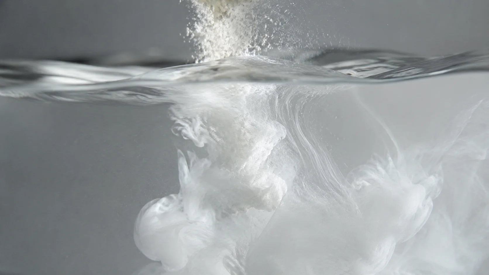 A white cloud-like form returning through moving water